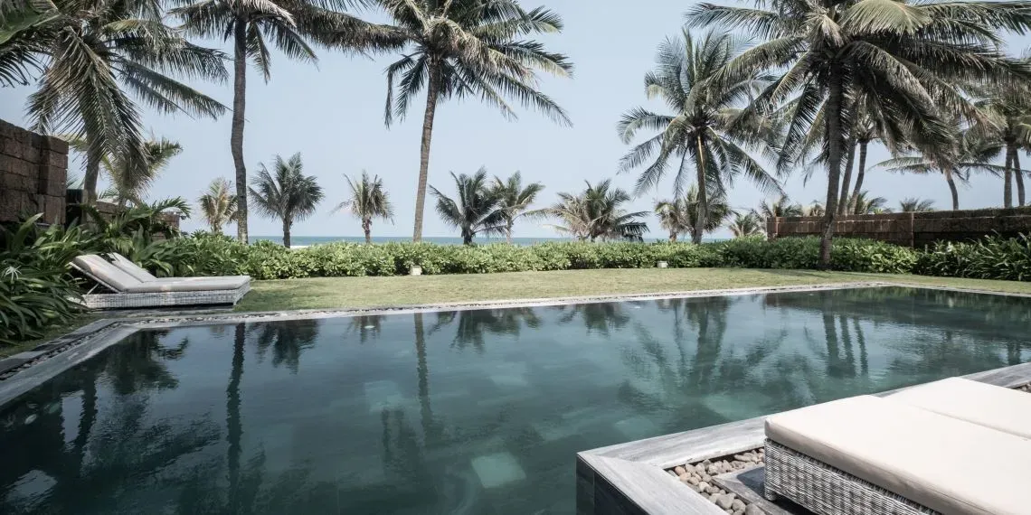 pool with view of ocean and palmtrees