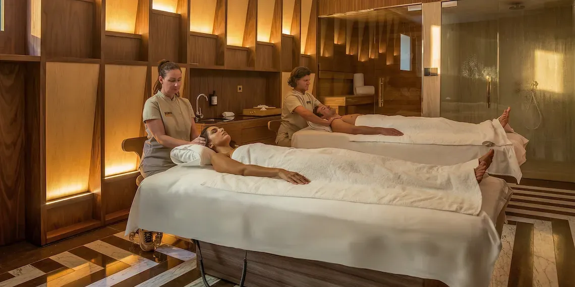 man and woman getting duo massage treatment next to each other