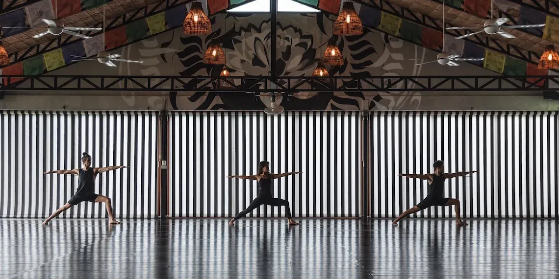 three people doing yoga