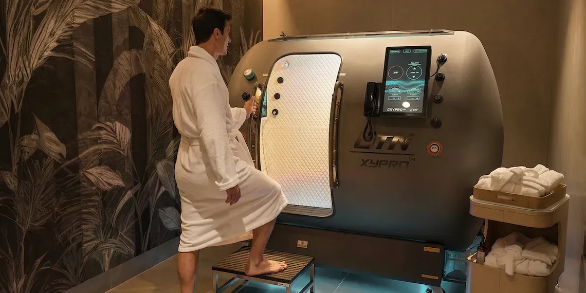man entering hyperbaric chamber in his bathrobe