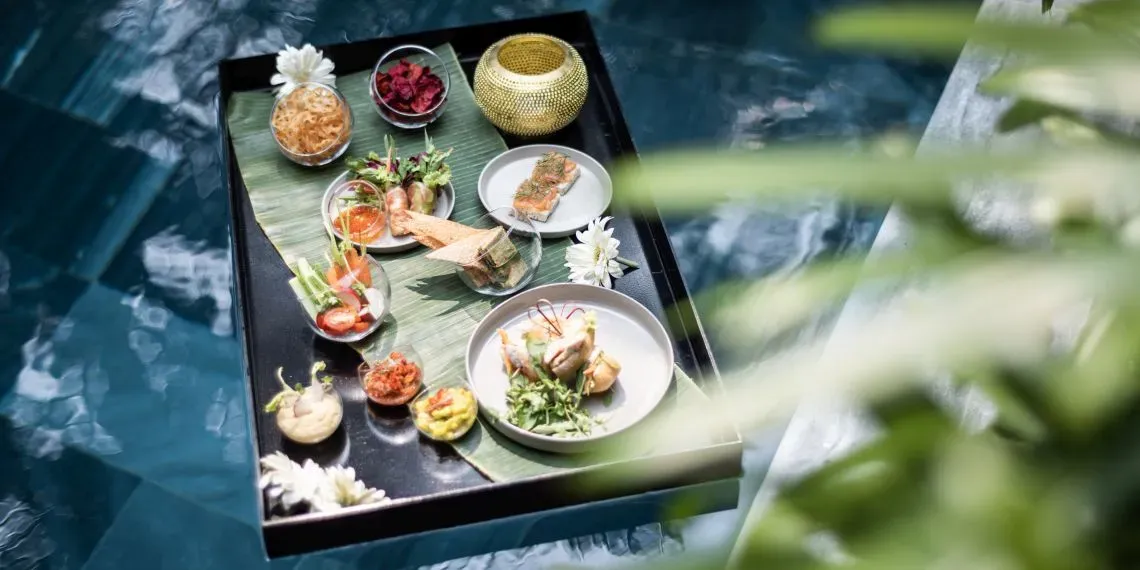 floating tray in pool with food and drinks