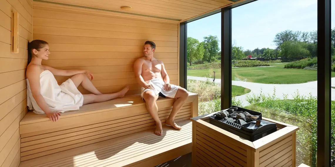 two people in the sauna with outdoor view