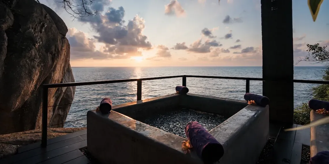 bath with view of sunset and ocean