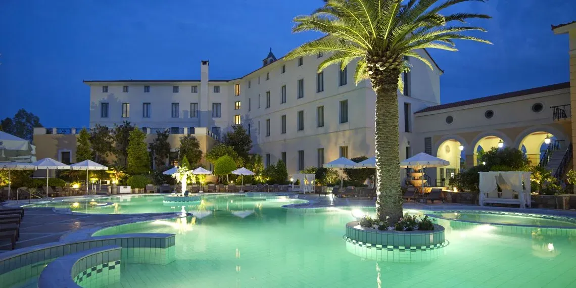 palm tree in a pool with white building