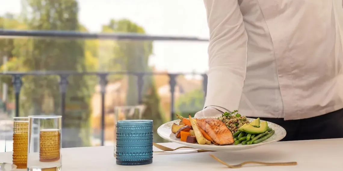 server showing food with salmon, vegetables and avocado 