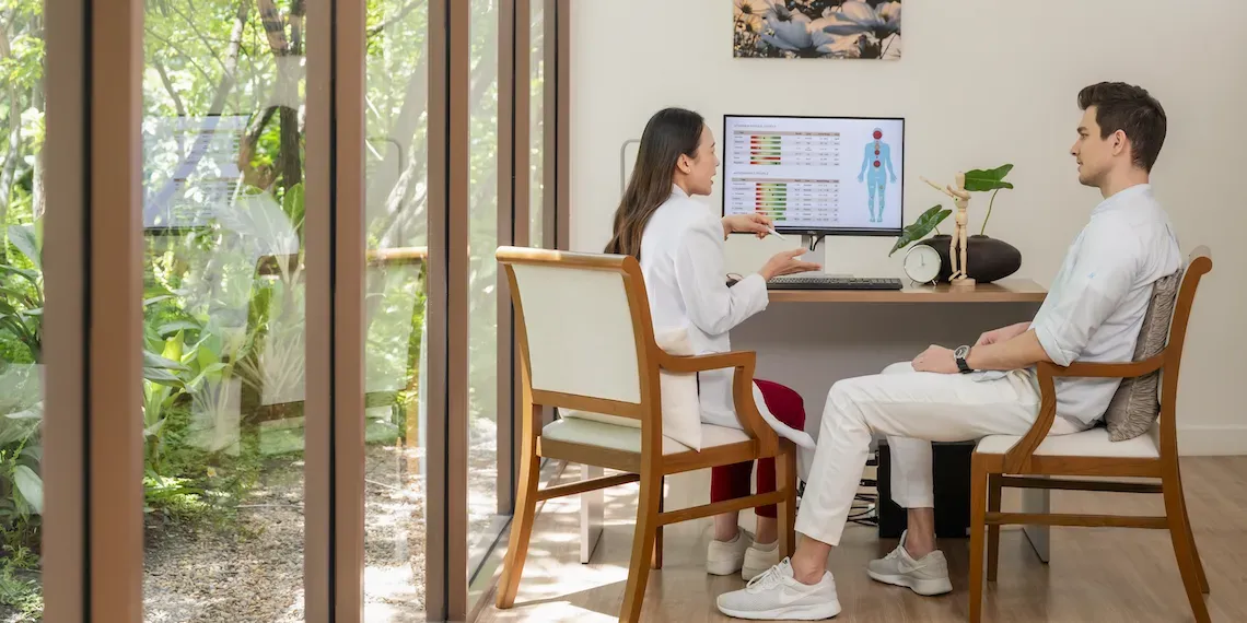 two people sitting watching a screen with medical results