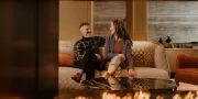 two people sitting in a lounge smiling