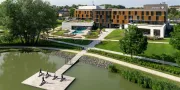 hotel with people doing yoga on the lake