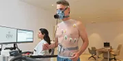 cardio clinic man with sensors on his body and doctor who is monitoring him
