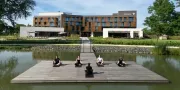 yoga on the lake with hotel in the background