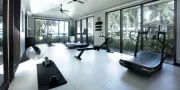 gym with workout machines and view of ocean and gardens