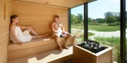 two people in the sauna with outdoor view