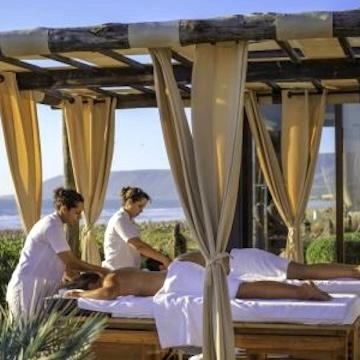 two people getting a massage on the beach