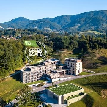 hotel in between mountains with greenery and trees